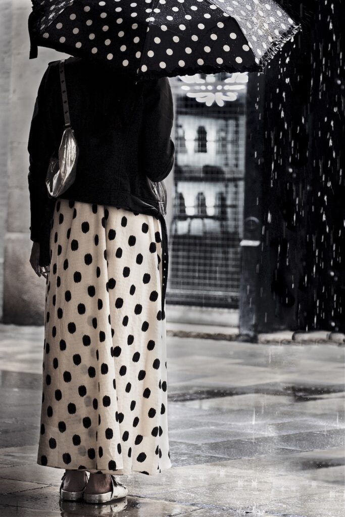 Woman waits in the rain on a Barcelona Street Photography tour