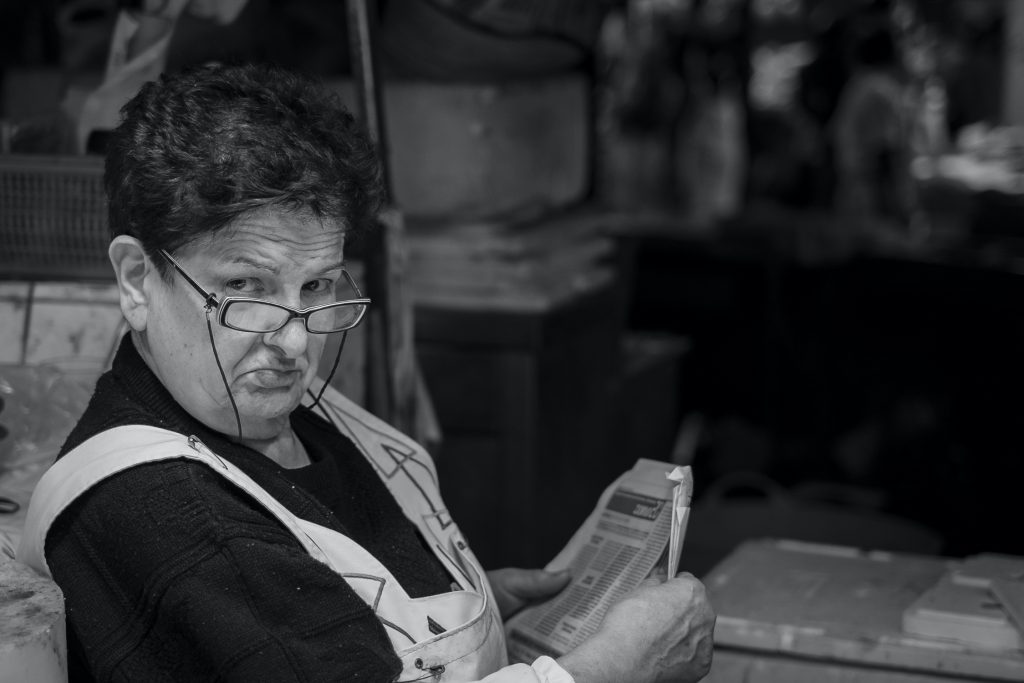 A fishmonger in the Boqueria market photographed during a Barcelona morning photography tour.