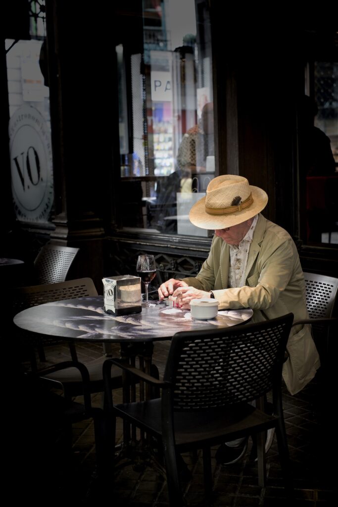 A man sits in a coffee shop in Seville on an Andalusia photography workshop